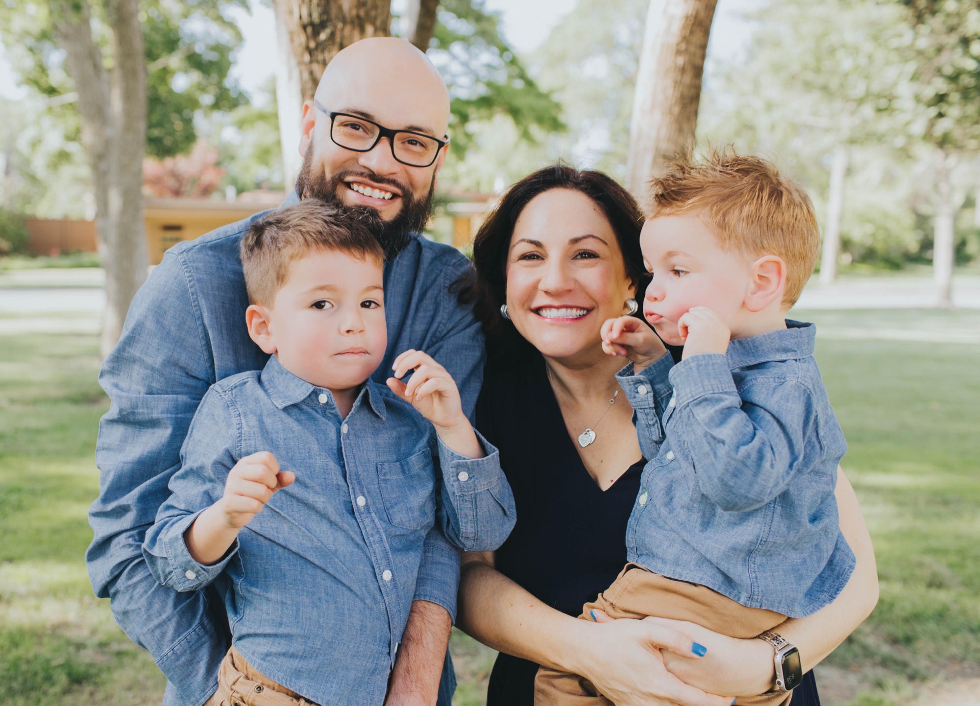 brothers making silly faces during summer family photos at the park