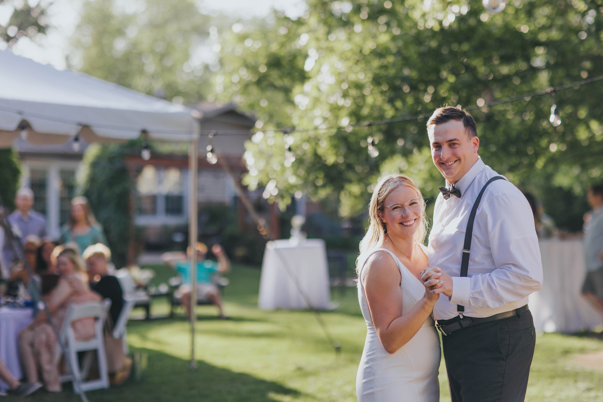 Bride and groom at their Oak Forest backyard wedding reception; Couple sharing first dance at Oak Forest backyard reception