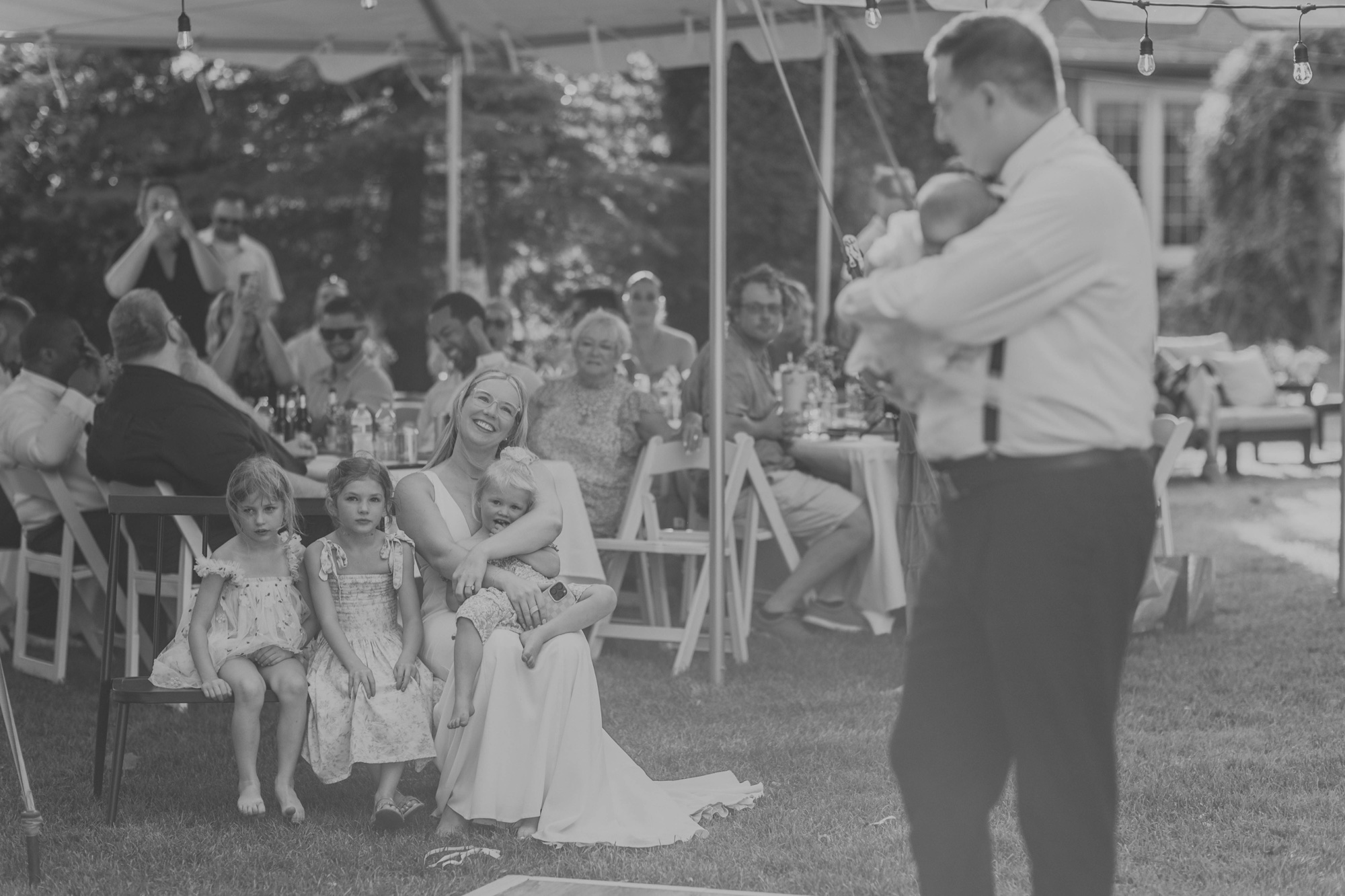 Father dancing with baby daughter under string lights at Oak Forest wedding
