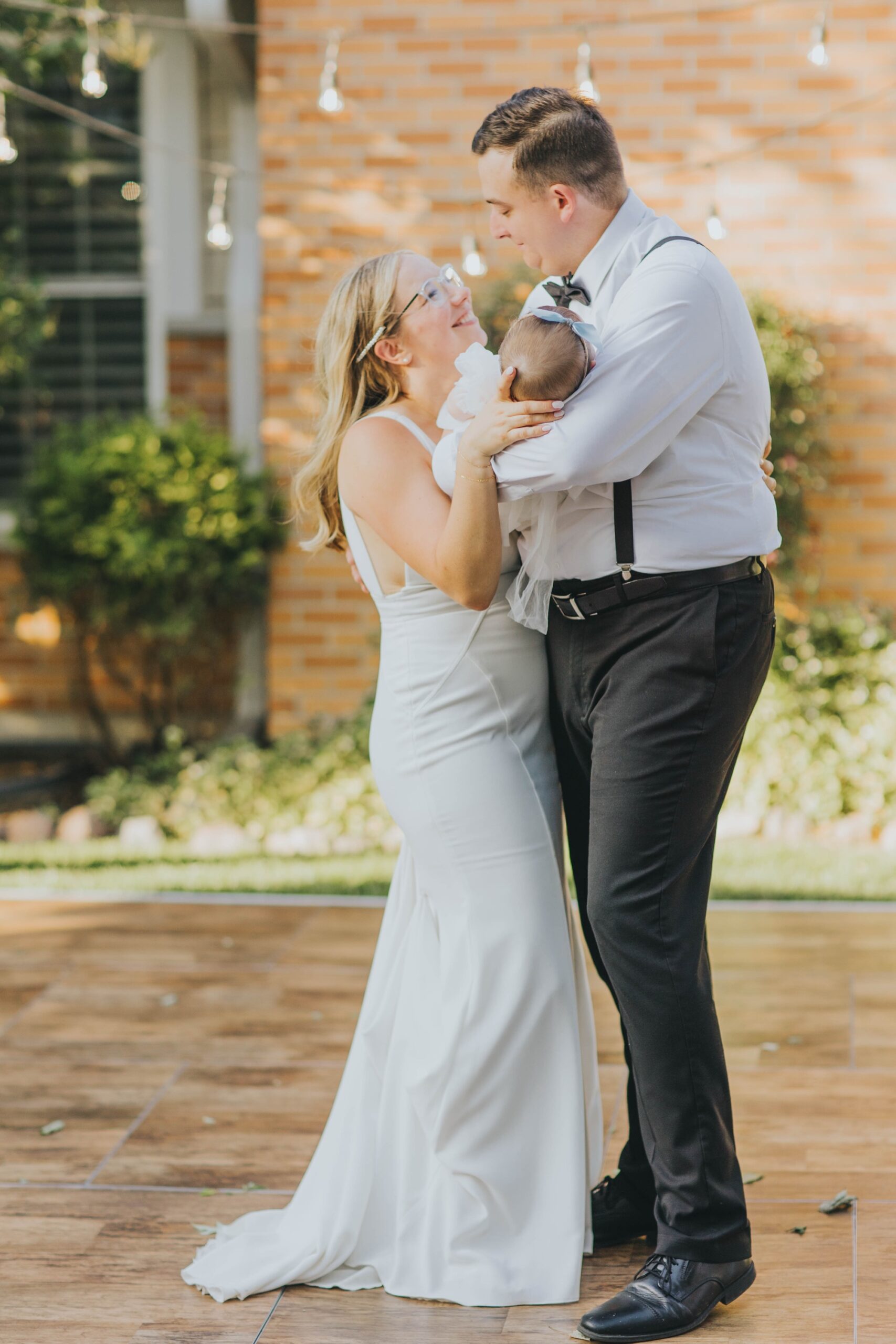 Bride and groom at their Oak Forest backyard wedding reception; Couple sharing first dance at Oak Forest backyard reception